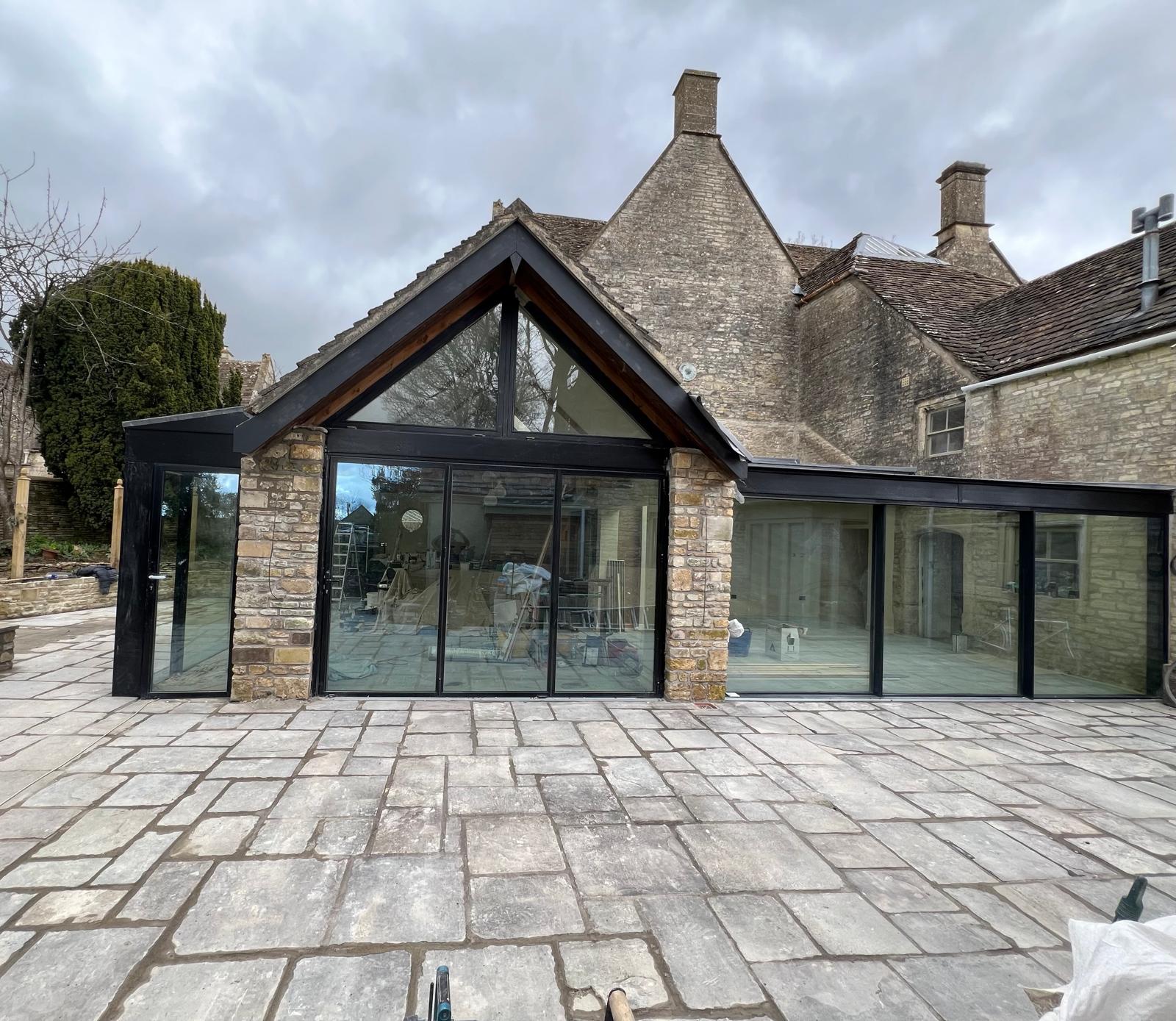 Completed stone and glass extension with renewed terrace