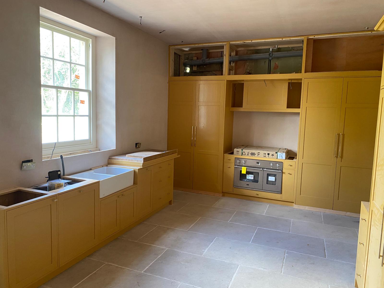 Second view of kitchen joinery installation in progress