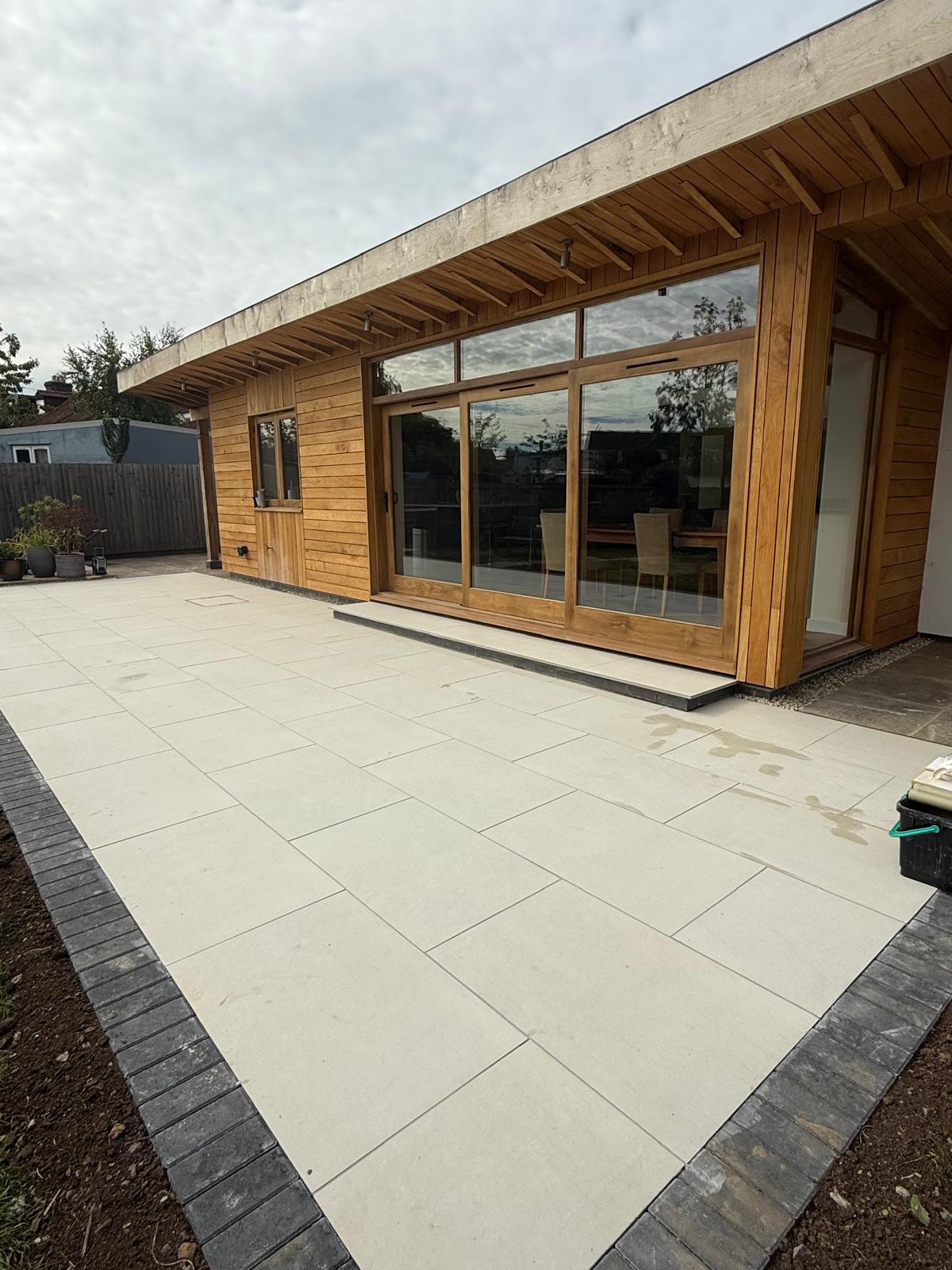 Alternate view of a timber-clad extension and patio