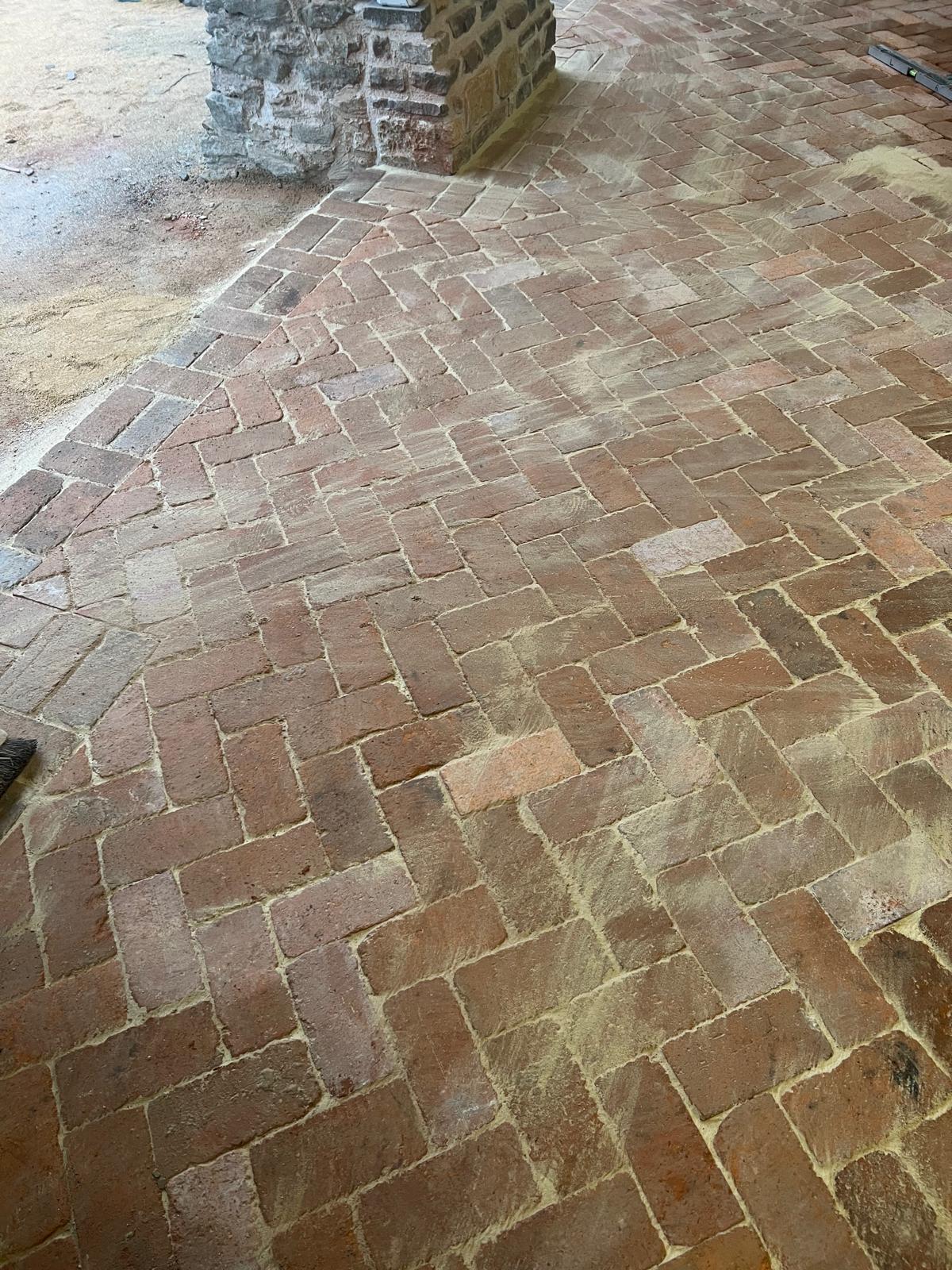 Reclaimed brick floor laid inside a stone building