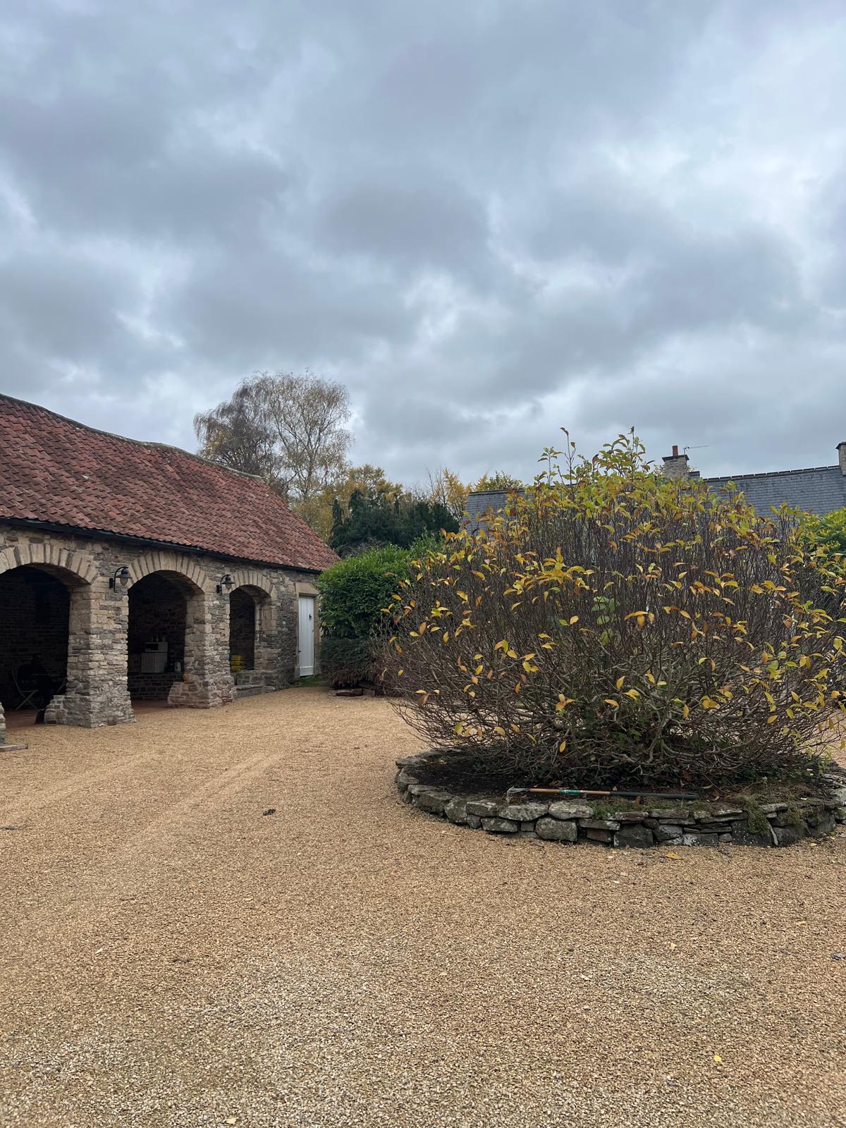 Stone outbuilding viewed across the site